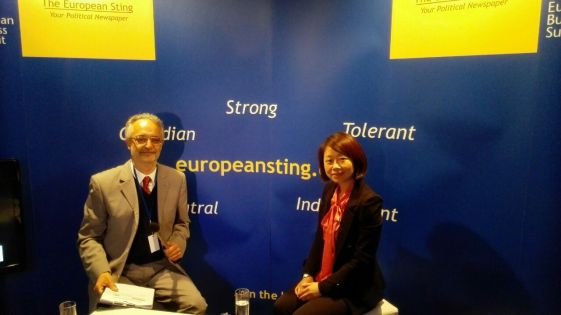 Mrs Xiaoyan Jiang is the Spokesperson of the Mission of the People's Republic of China to the European Union. Mrs Xiaoyan is depicted in the photo together with the European Sting's Editor in Chief, Mr Dennis Kefalakos, during the live interview taken at the Sting's pavilion in European Business Summit 2015.